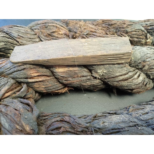 89 - Marie Rose, The Solent, 1545 A coil of tarred rope and wooden wedge Approximately 120cm in length, 5... 