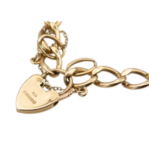 100 - A 9ct gold curb link bracelet with padlock clasp, applied with a smoky quartz pendant. Stamped 375, ... 