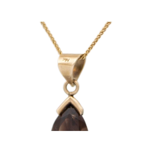 101 - A 9ct gold fancy link chain with 14ct gold smoky quartz pendant. The pendant stamped 14K, length 25m... 