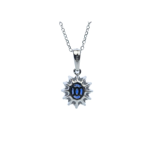 112 - An attractive 18ct white gold oval sapphire and diamond cluster pendant on 18ct chain. The sapphire ... 