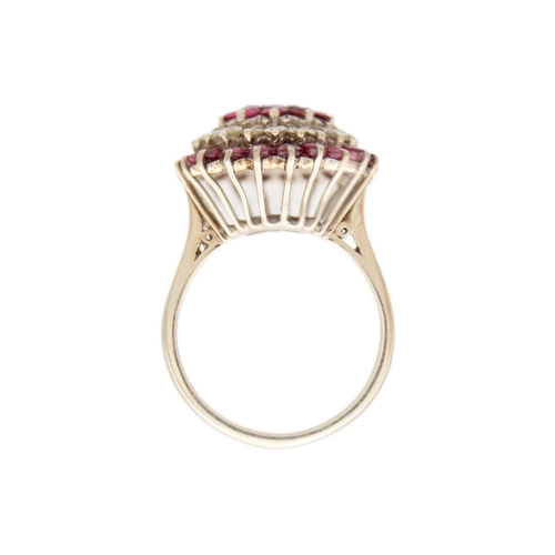 120 - An 18ct white gold ruby and diamond set cluster target ring. The central principle diamond of 0.15ct... 