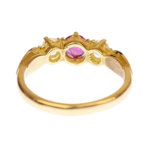 121 - An 18ct ruby and diamond three-stone ring. The round cut ruby of 0.58ct estimated weight, the round ... 