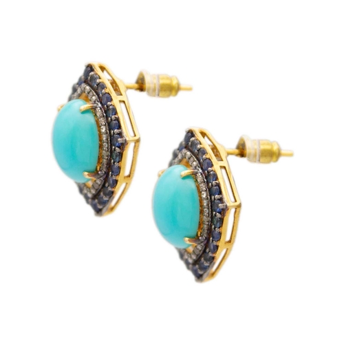 128 - A pair of vintage style earrings set with a large oval turquoise, sapphires and diamonds. Set in sil... 