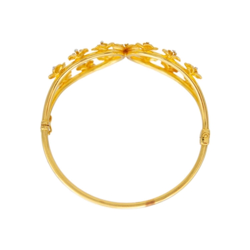 133 - High purity gold bangle applied with flower heads Stamped 916, 26.88g weight. Comes in original Aluk... 