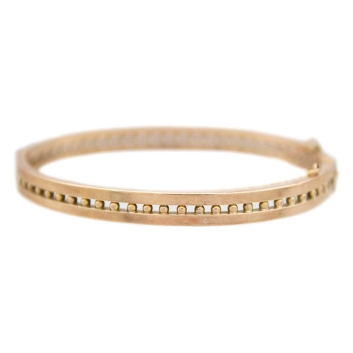 135 - A 9k rose gold bangle bracelet The bangle is 5.7x4.6cm in inner width, 7.78g, stamped 9k.