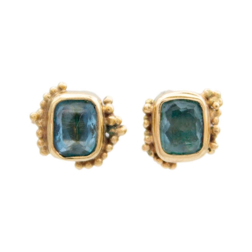 143 - A pair of gold earrings with blue gemstones by Rebecca M Smith. The blue stone earrings are 8x8mm wi... 