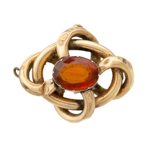 155 - A Victorian high-purity gold (tests 14ct) large citrine set knot brooch. Comprising hollow loops, th... 