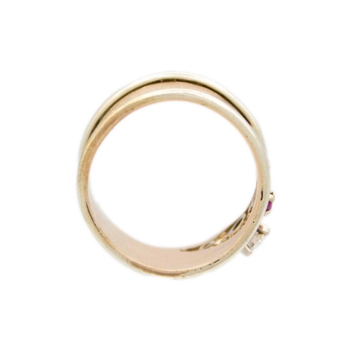 159 - A high purity gold (tests 14ct) wide band ring with central CZ and two red spinels The ring is in si... 