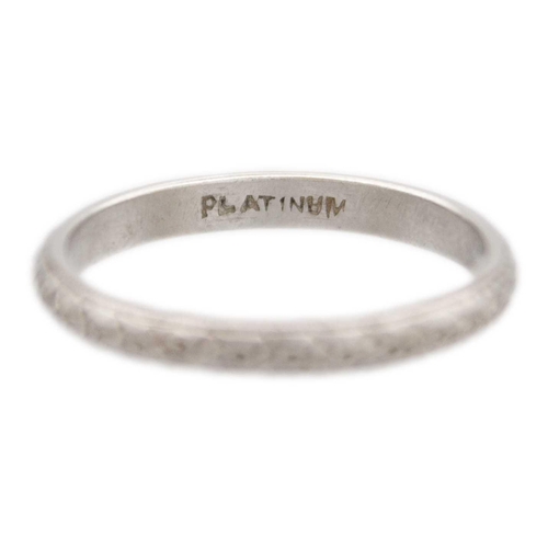 165 - A platinum band ring with engraved decoration. Stamped PLATINUM, size L, 3.1g.