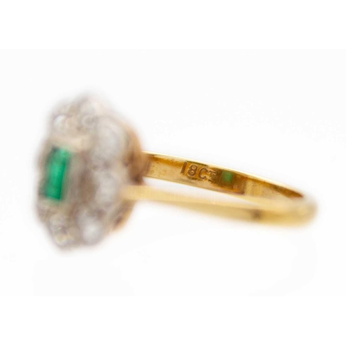 181 - An attractive 18ct emerald and diamond set cluster ring. The millegrain set emerald cut emerald of 0... 