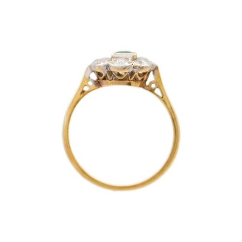 181 - An attractive 18ct emerald and diamond set cluster ring. The millegrain set emerald cut emerald of 0... 