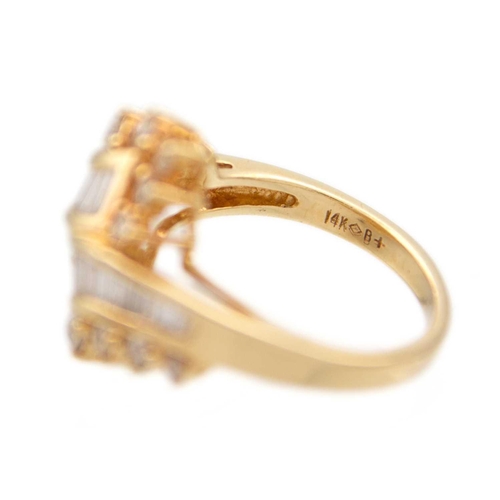 186 - A good 14ct contemporary diamond set crossover ring. Channel set with 23 tapered baguette diamonds, ... 