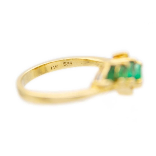 194 - A 14k gold seven claw set marquise cut emerald ring The ring comes in original 'Colombian Emeralds I... 