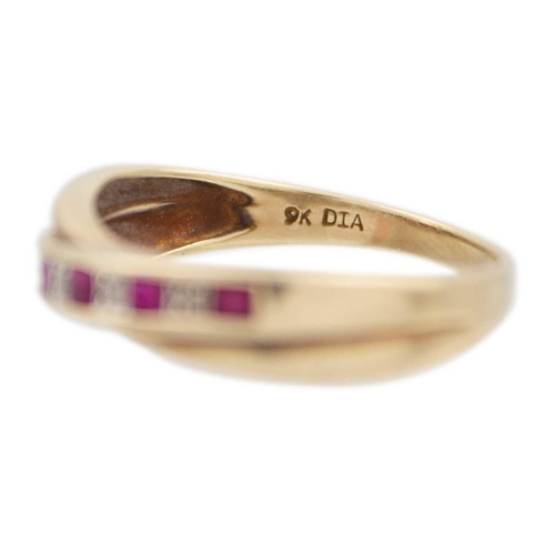 219 - A 9ct yellow gold ruby and diamond crossover half eternity ring The ring has five square cut rubies ... 