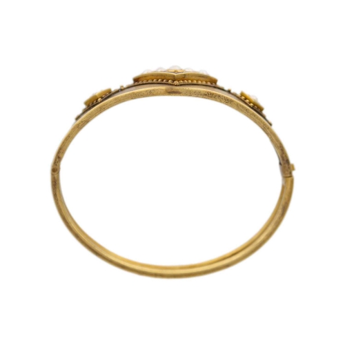 220 - A high purity (tests 14ct) gold Etruscan revival hinged bangle Set with natural cultured half pearls... 