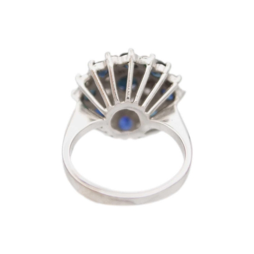 222 - An 18k white gold sapphire and diamond cluster ring Size M, head 1.8cm diameter, 7.93g.