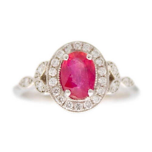 230 - A 1.03ct ruby and diamond set halo ring, set in 18ct white gold. By River Mounts. The oval cut ruby ... 