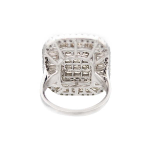 231 - An impressive large 9ct white gold diamond set cocktail ring. The rounded square head set with bague... 