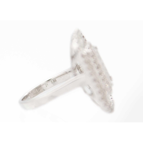 231 - An impressive large 9ct white gold diamond set cocktail ring. The rounded square head set with bague... 