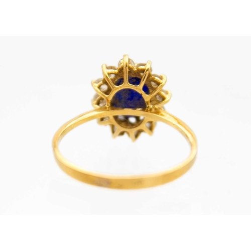 257 - An 18ct blue synthetic sapphire and cz set cluster ring. The oval cut sapphire measuring 8 x 6.2 x 4... 