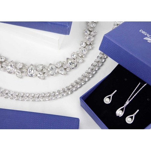 271 - Swarovski - two necklaces and a pendant necklace and earring set. Within boxes. Together with three ... 