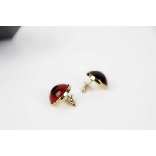 284 - Lalique - A pair of modern cabochon red crystal stud earrings. In gold tone metal, stamped marks to ... 