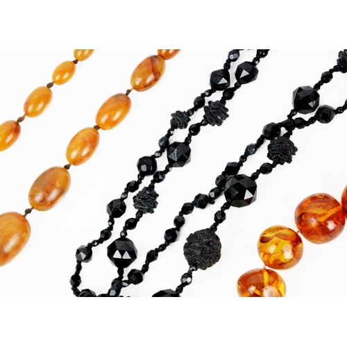 298 - A bakelite 'amber' graduated bead necklace and a jet bead necklace with matching earrings. The 'ambe... 