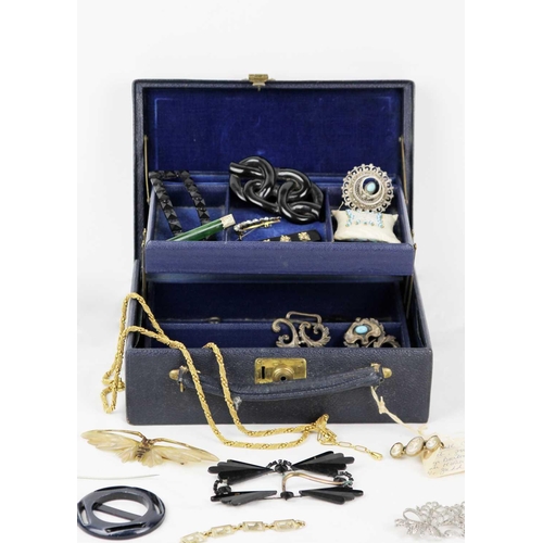 299 - A jewellery box containing costume jewellery. To include a black onyx brooch with gold mounted leave... 