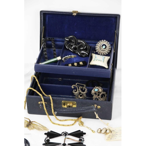 299 - A jewellery box containing costume jewellery. To include a black onyx brooch with gold mounted leave... 