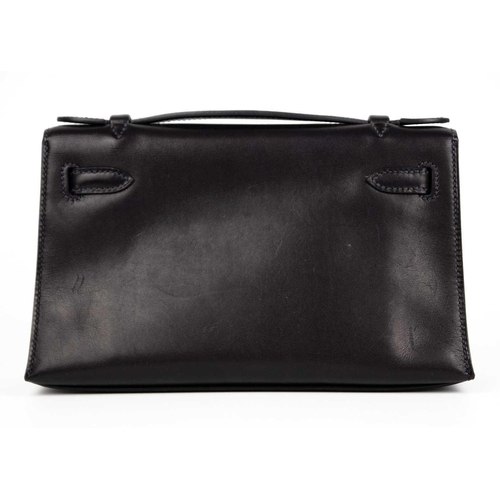 301 - HERMES - A Kelly Pochette clutch bag with Palladium hardware. In Swift navy leather with Palladium h... 