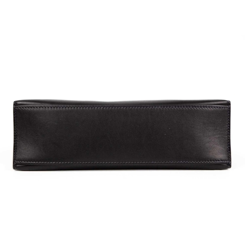 301 - HERMES - A Kelly Pochette clutch bag with Palladium hardware. In Swift navy leather with Palladium h... 