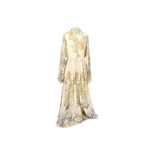 306 - JEAN VARON - A 1970's maxi dress. Printed with autumnal foliage and a game bird on a cream ground, l... 