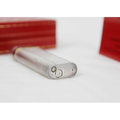 316 - MUST DE CARTIER - A silver plated Grain D'orge lighter with burgundy enamel band. Serial number 1177... 