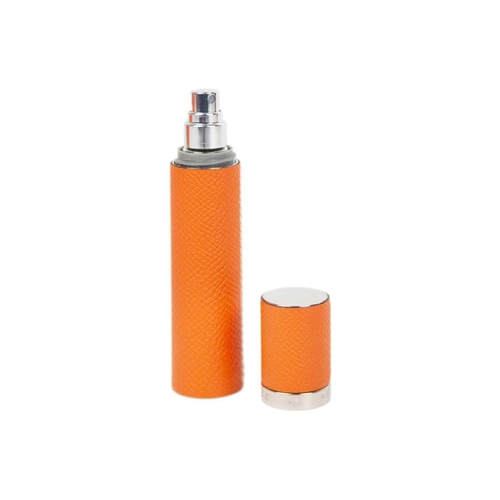 320 - HERMES - An unused orange leather-cased glass refillable perfume atomizer. Within original canvas po... 