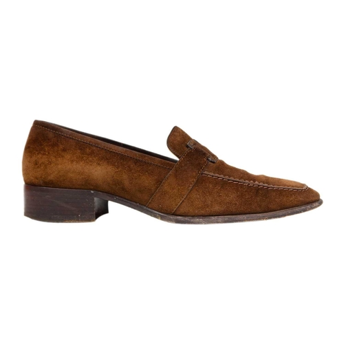 325 - Two pairs of Hermès shoes. A pair of brown suede loafers, UK size 6, with a pair of black leather po... 