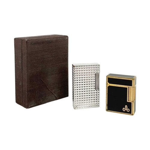 353 - S. T. DUPONT - Two lighters. One in a chrome nickel case, with box and papers, the other gold plated... 