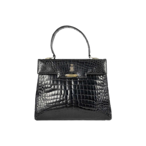 354 - A good vintage black crocodile leather handbag. The flap applied with a Baroness coronet and monogra... 