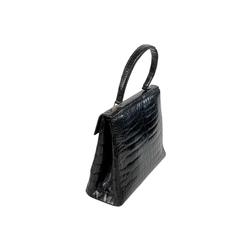 354 - A good vintage black crocodile leather handbag. The flap applied with a Baroness coronet and monogra... 