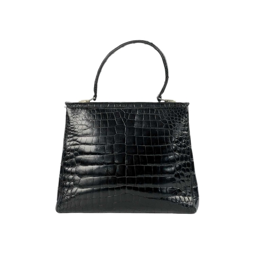 354 - A good vintage black crocodile leather handbag. The flap applied with a Baroness coronet and monogra... 