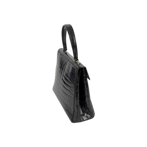 354 - A good vintage black crocodile leather handbag. The flap applied with a Baroness coronet and monogra... 