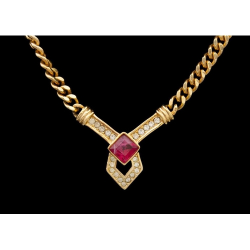 357 - CHRISTIAN DIOR - A gold-tone paste set pendant necklace. The V shaped pendant on a curb link chain, ... 