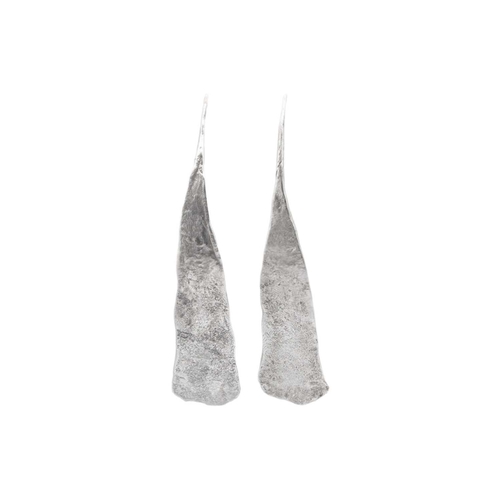 38 - EMILY NIXON - A pair of large silver earrings with gold hook fittings. On elongated flattened form, ... 