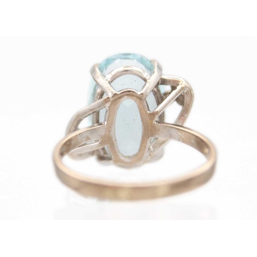 41 - A platinum aquamarine set dress ring. The oval cut aquamarine of 4.15ct estimated weight, in a four ... 