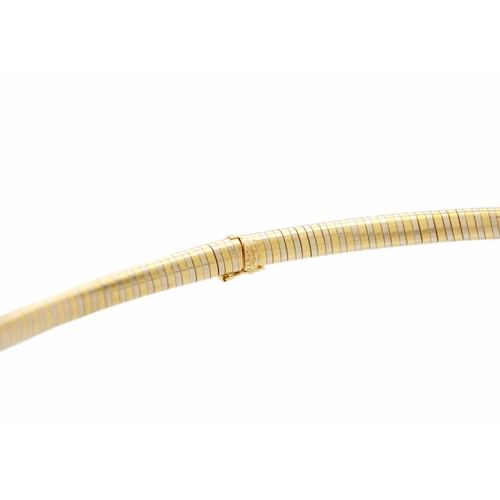 49 - CARTIER - An 18ct bi-colour omega collar. In white and yellow gold, stamped Cartier, stamped with se... 