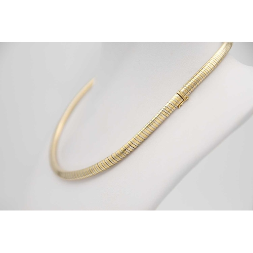 49 - CARTIER - An 18ct bi-colour omega collar. In white and yellow gold, stamped Cartier, stamped with se... 