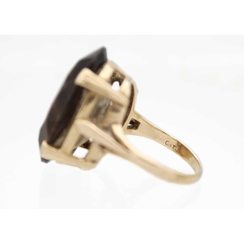 76 - A 9ct hallmarked gold, large smoky quartz set, cocktail ring. Size O, 10.0g.