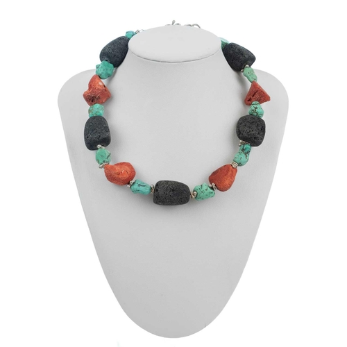 77 - HELEN FEILER - A volcanic stone and turquoise bead silver necklace. With silver wire spacers, length... 