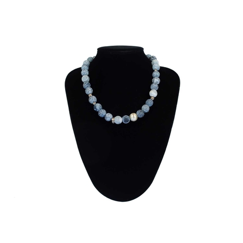 78 - HELEN FEILER - A volcanic blue and white stone and silver bead necklace. Length 45cm.