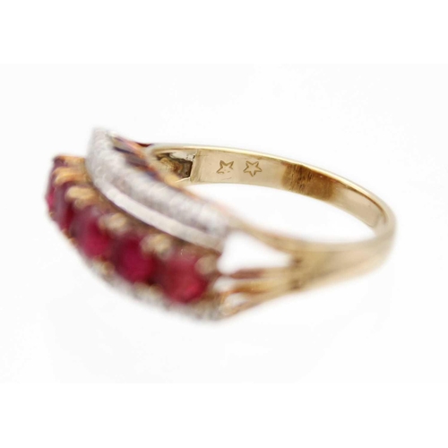 81 - A 14ct ruby and diamond set ring. Set with a row of five round cut rubies each of 0.20ct, and a flan... 