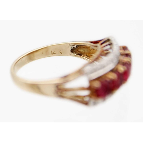 81 - A 14ct ruby and diamond set ring. Set with a row of five round cut rubies each of 0.20ct, and a flan... 